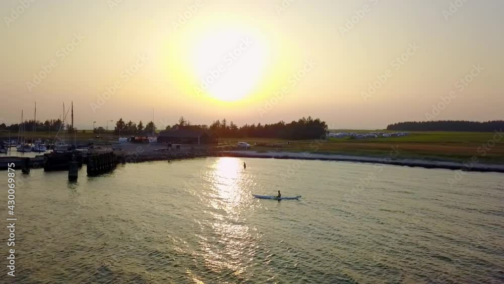 Silhouette of a man with a kayak at sunset Silhouette of a man with a kayak at sunset