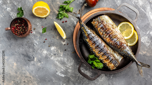 Grilled mackerel fish with lemon herbs and spices, banner, menu recipe place for text, top view photo