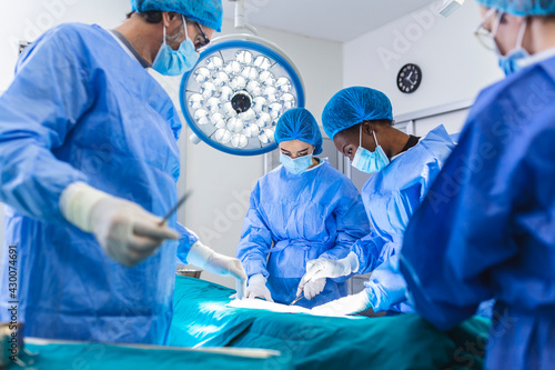 Surgeons performing operation in operation theater. breast augmentation surgery in the operating room surgeon tools implant. Medical care concept. photo