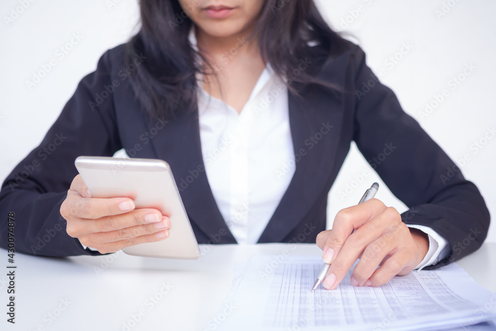 Staff business woman with black suit holding mobile or smartphone and check data of document. planing earn money investment and saving money future for 2022 new year. finance and business concept. Staff business woman with black suit holding mobile or smartphone and check data of document. planing earn money investment and saving money future for 2022 new year. finance and business concept.