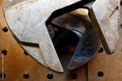 Macro wrench or spanner on wooden pegboard