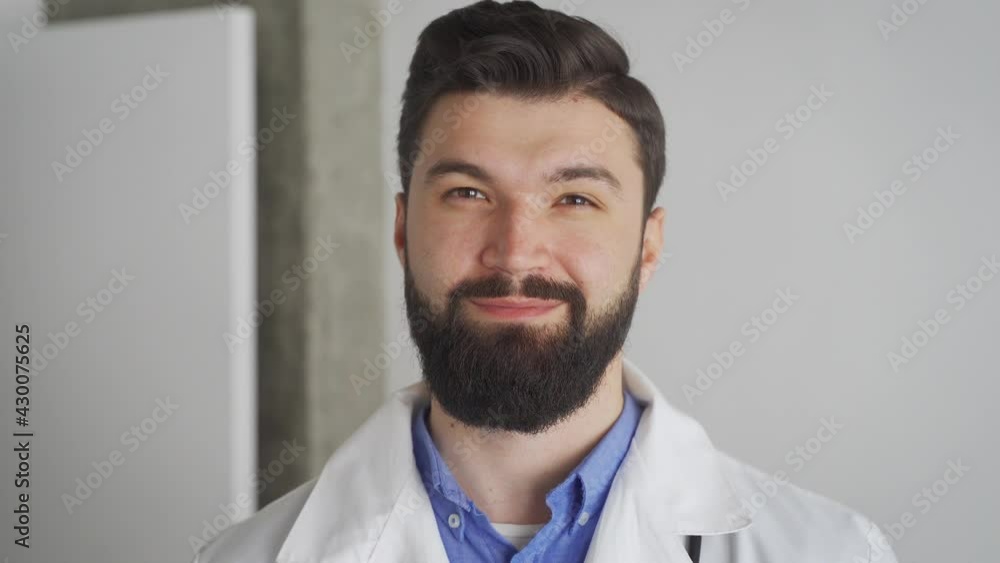Caucasian male doctor looking at camera with friendly smile close up portrait Caucasian male doctor looking at camera with friendly smile close up portrait