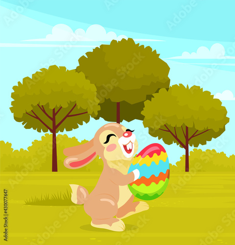 Smiling and happy Easter Rabbit  or Easter Bunny holding egg with color pattern  while running. Festive gray hare joyfully gallops across clearing with trees. Cheerful spring holiday celebration