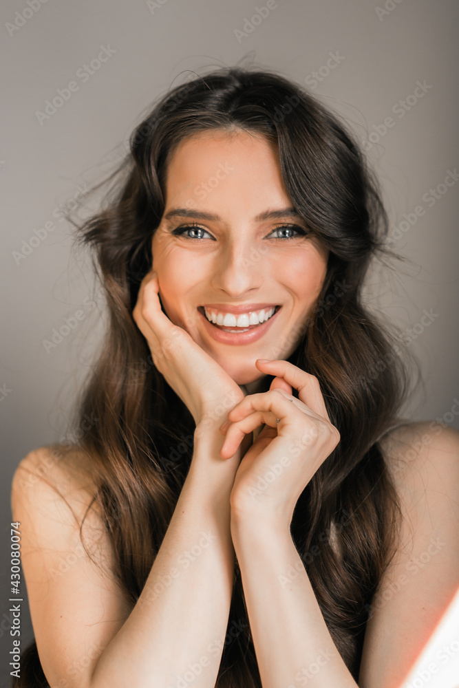 Portrait of a smiling young brunette woman, model, enchanted look, looking at the camera. Portrait of a smiling young brunette woman, model, enchanted look, looking at the camera.