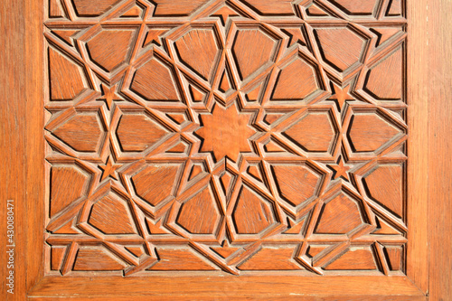 Closeup historical Islamic geometric wooden door decoration detail made with a traditional technique called "kundekari" in Istanbul, Turkey.