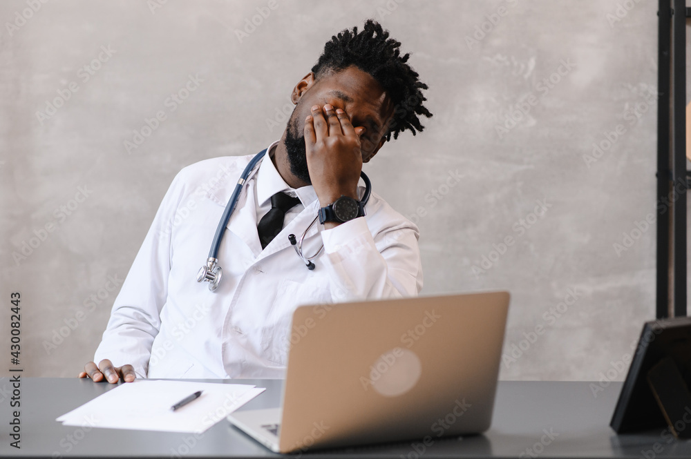 Funny bored at work african american doctor worker falling asleep at office desk, employee sleeping at workplace near laptop feel overworked concept Funny bored at work african american doctor worker falling asleep at office desk, employee sleeping at workplace near laptop feel overworked concept