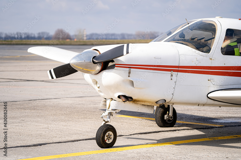 Front side white jet plane standing on wide road. Front side white jet plane standing on wide road.