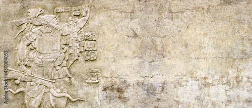 Obraz na plátne Grunge background with stone wall texture and bas-relief of a Mayan king Pakal