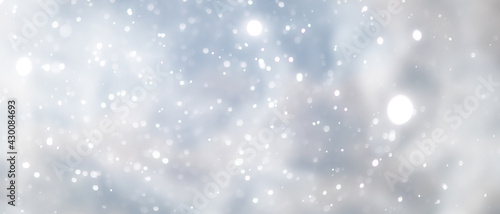 blue snowfall bokeh background, abstract snowflake background on blurred abstract blue © alexkich