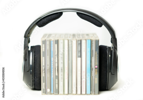 Headphones On Stack Of Cds Listening to music concept. photo