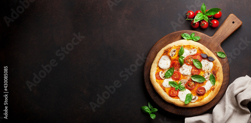 Italian pizza with tomatoes, mozzarella and basil