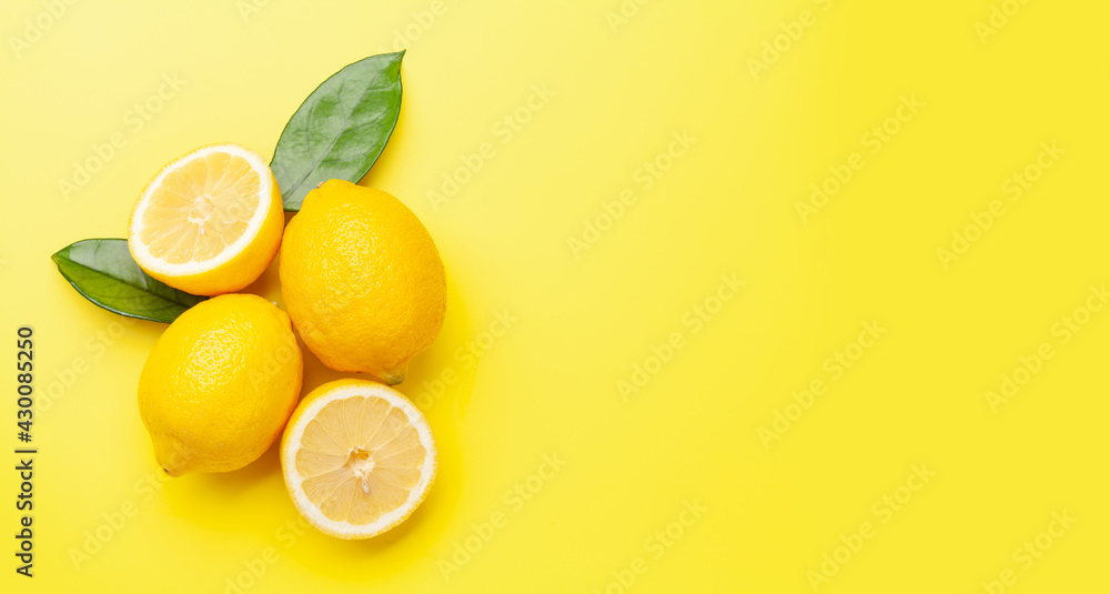Fresh ripe lemons on yellow background Fresh ripe lemons on yellow background