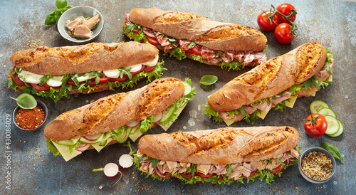 Εκτύπωση καμβά Various sub sandwiches and ingredients on table