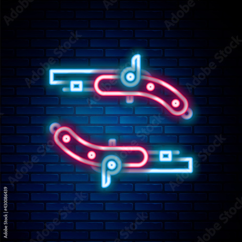 Glowing neon line Vintage pistols icon isolated on brick wall background. Ancient weapon. Colorful outline concept. Vector