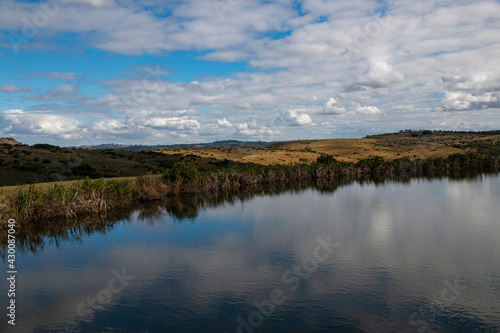 Clouds and Blue Sky Reflected on Surface of Rural Pond