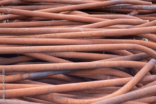 Old rusty iron pipes. Photo on the topic of recycling scrap metal or replacing old pipes.