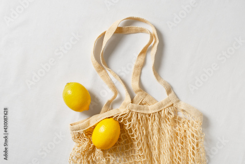 Zero waste concept with string bag, mesh bag, grosery bag with lemon on white background