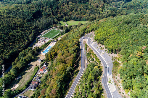 Winding road serpentine from a high mountain pass in the rhine village Bendorf Sayn Germany Aerial view
