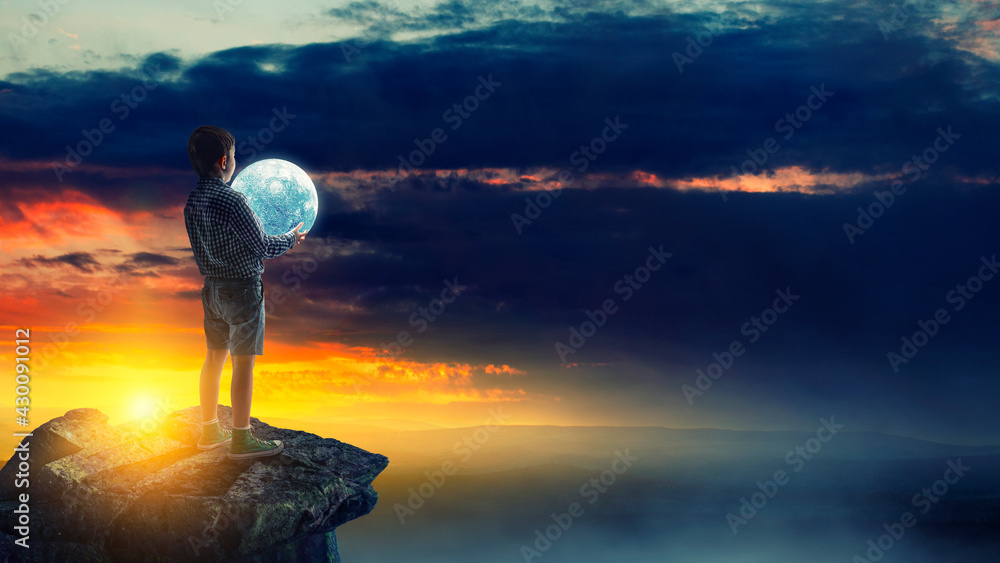 Obraz premium Boy holding moon at night