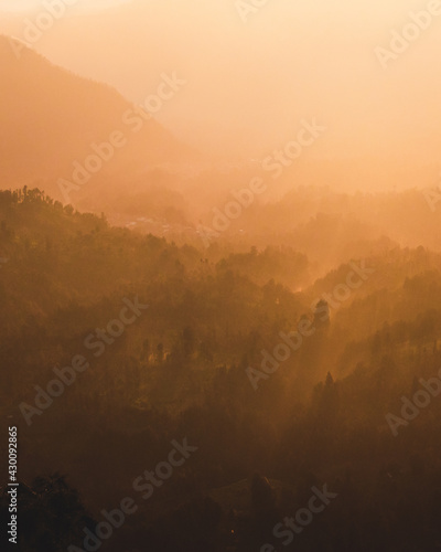 Eerie scenery of mountains in the golden haze photo