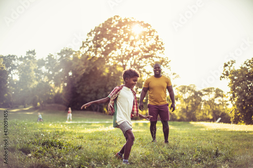 African American father and son having fun in nature.