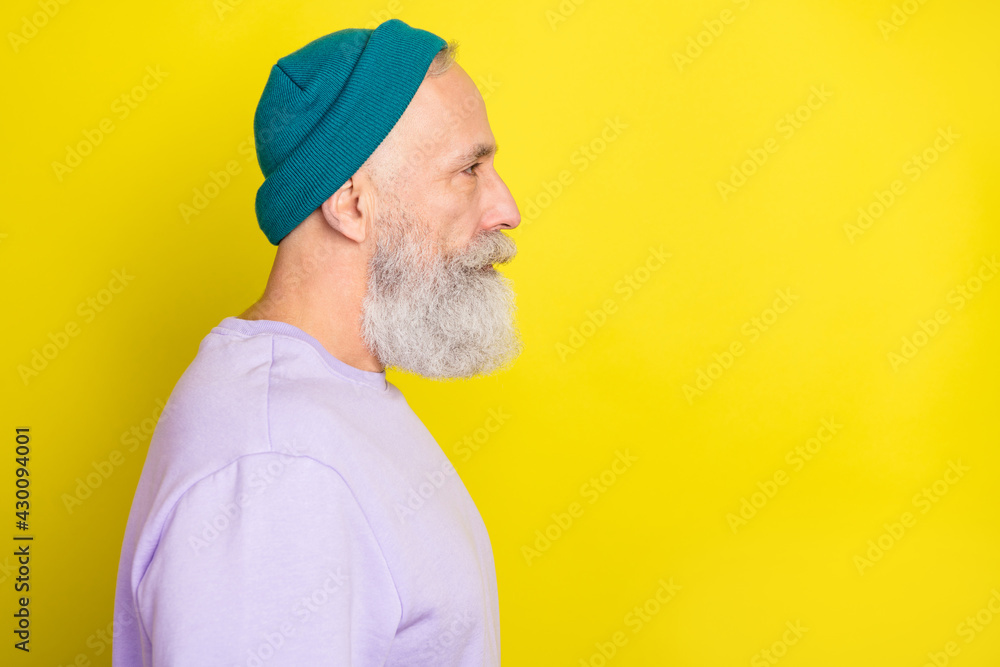 Photo of handsome pretty age gentleman wear violet sweater headwear looking empty space isolated yellow color background Photo of handsome pretty age gentleman wear violet sweater headwear looking empty space isolated yellow color background
