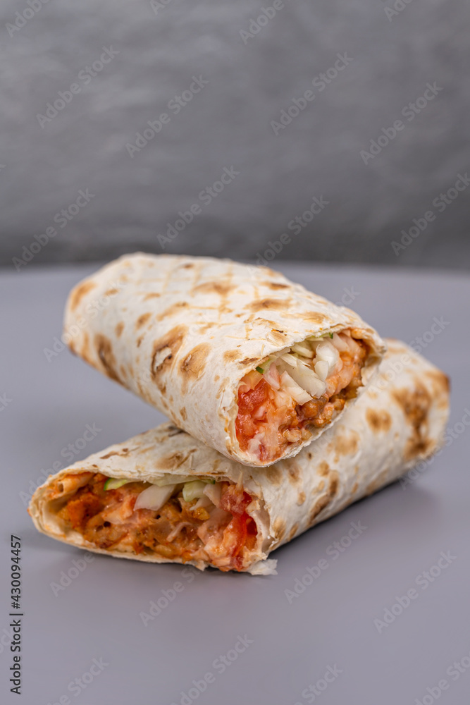 doner with meat filling in a cut on a gray background