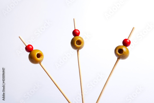 Isolated olives on skewers with white background