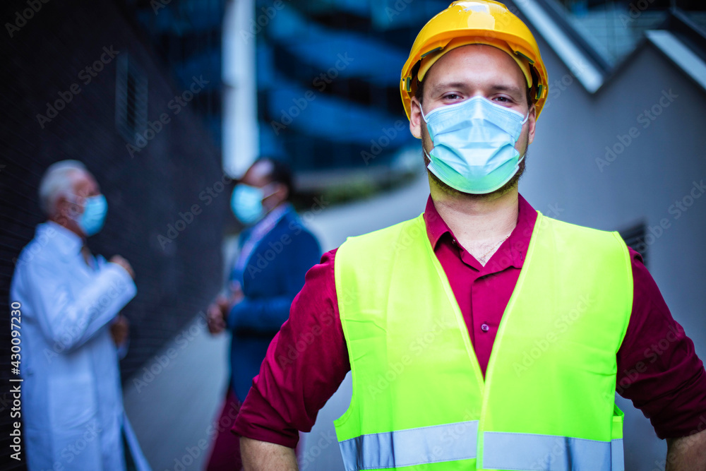 Business man, doctor and engineer on street. Focus is on man with helmet. Business man, doctor and engineer on street. Focus is on man with helmet.