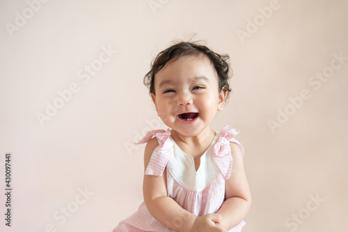 Portrait of a cute happy little Asian baby girl who recently had baby tooth laughing and look at camera, baby expression concept