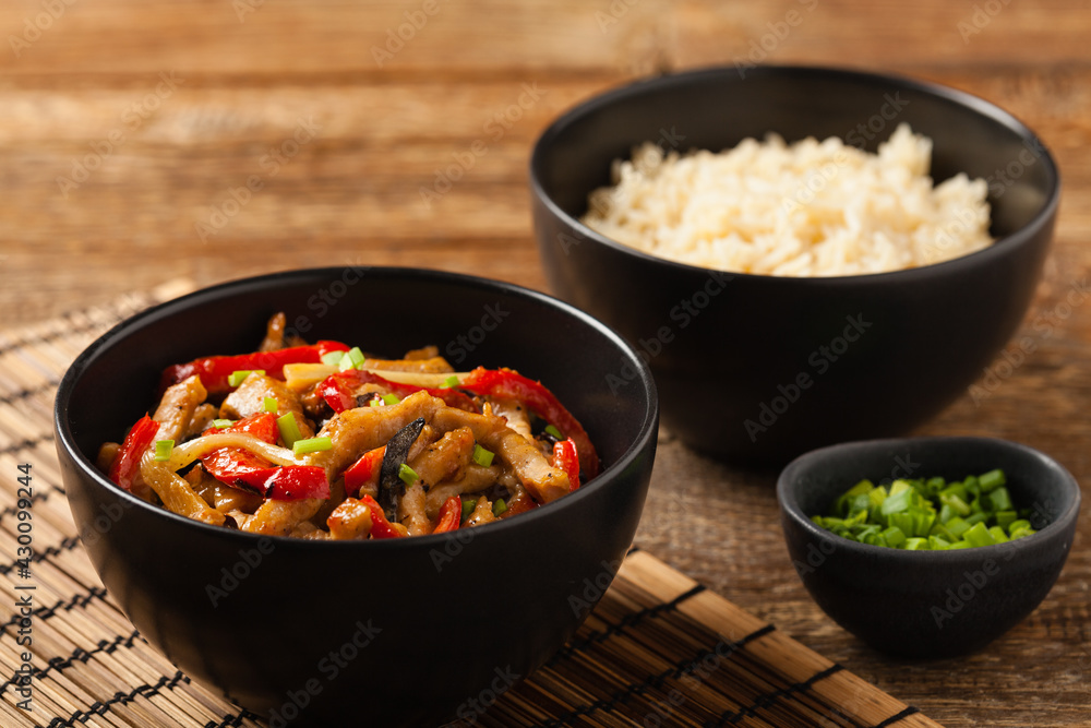Pork chop with peppers, mushrooms and bamboo. Served with rice. Pork chop with peppers, mushrooms and bamboo. Served with rice.