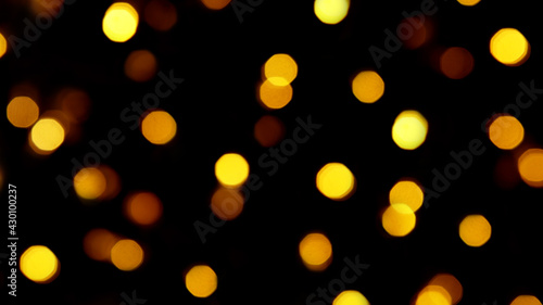 Blurry golden bokeh lights on a black background