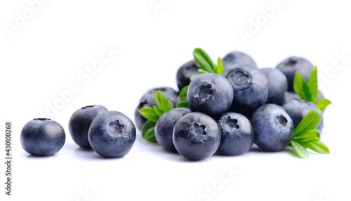 Heap of blueberries with leaves on white backgrounds.
