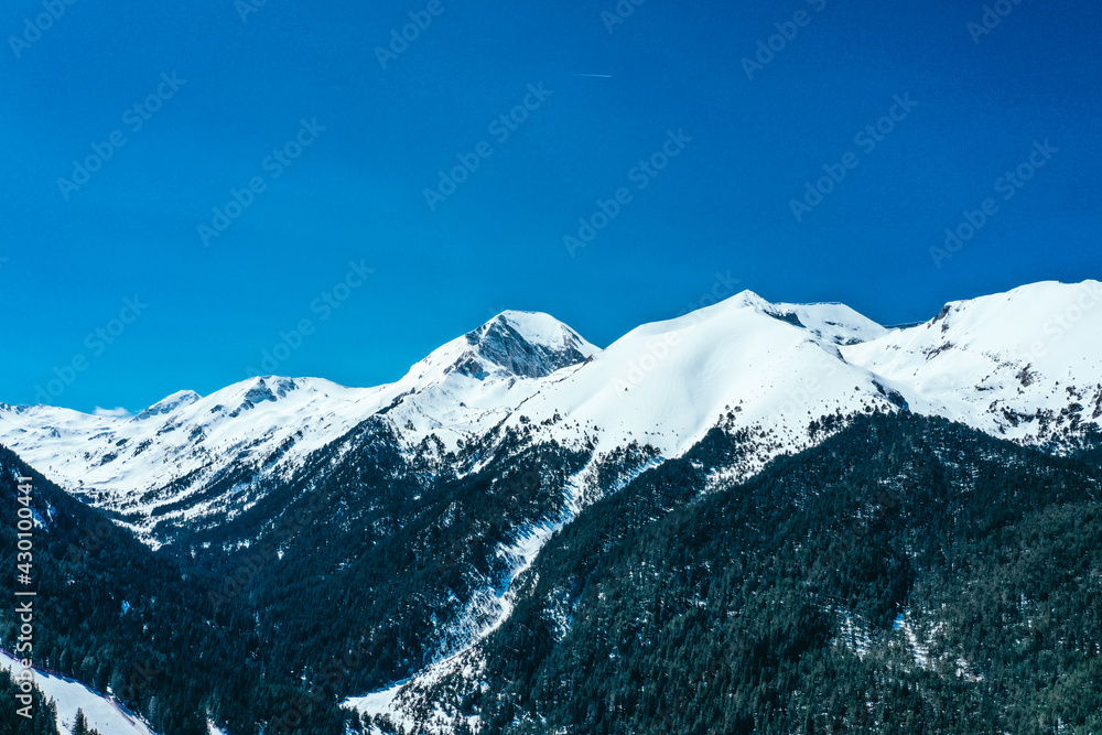 Balkans, Todorka mountain peak, ski tracks, covered with snow. Beautiful alpine natural winter backdrop. Pirin ice top of the hill on the blue sky background.
