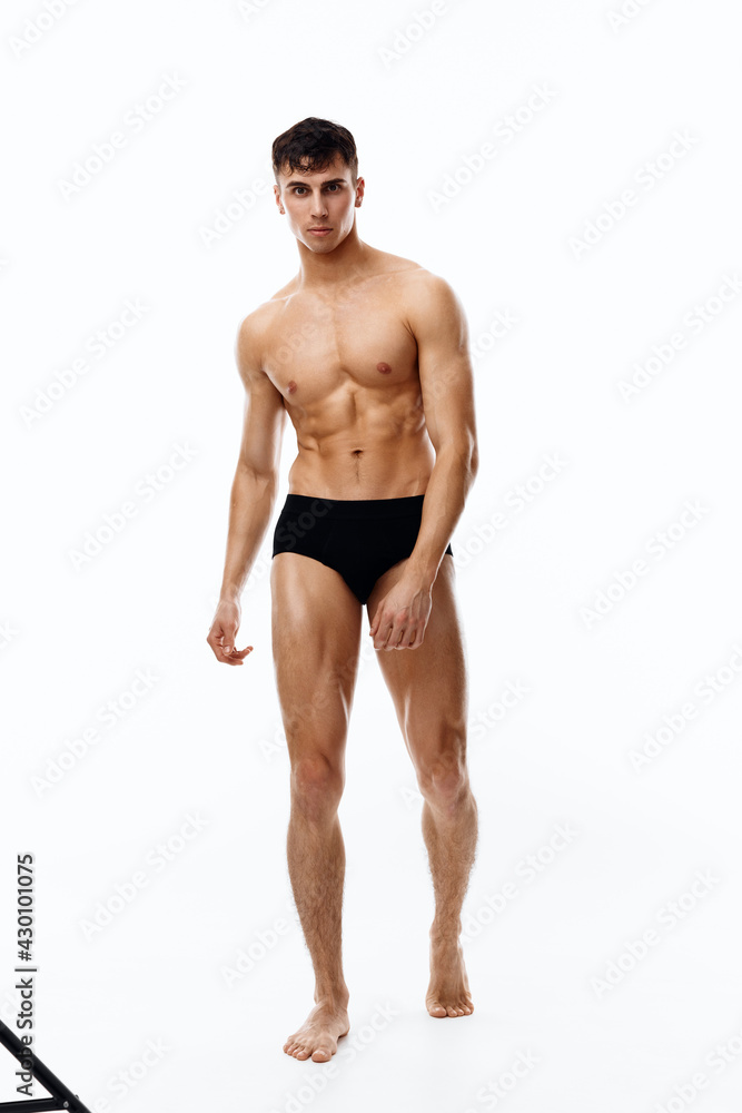 man athlete in full growth on a light background black panties man athlete in full growth on a light background black panties