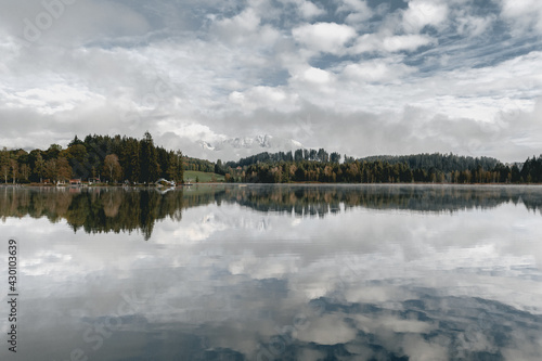 Reflection of the sky and forest in a mountain lake