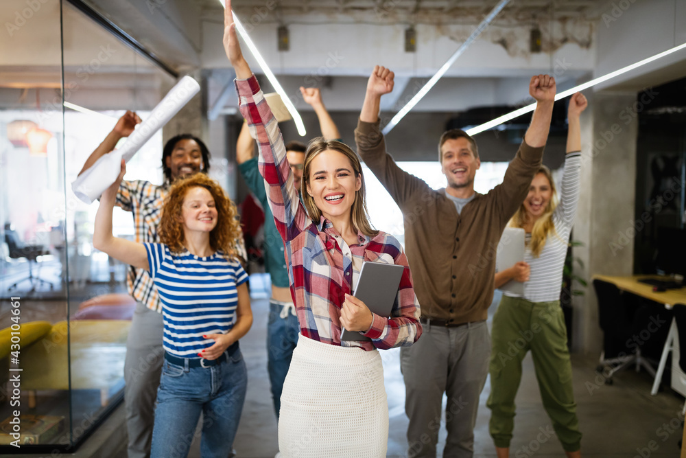 Fototapeta premium Group of successful happy business people in office celebrating profits