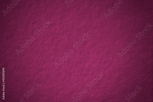 Magenta concrete textured background blank space with vignette