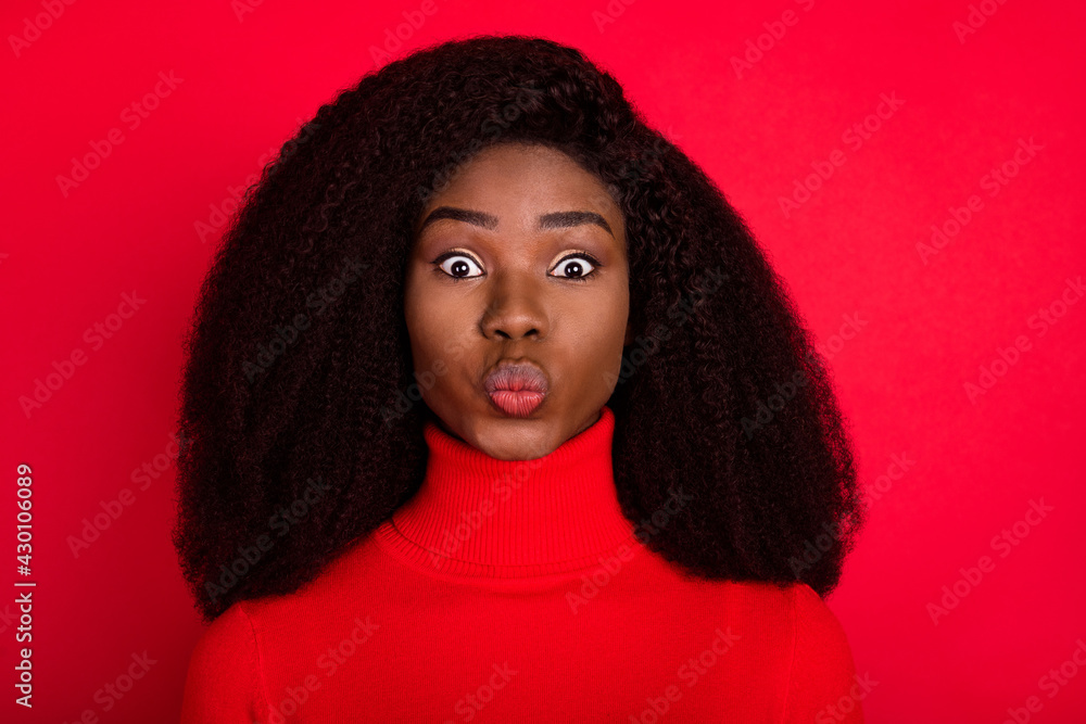 Photo of young attractive african woman pouted lips send air kiss love romantic isolated over red color background Photo of young attractive african woman pouted lips send air kiss love romantic isolated over red color background