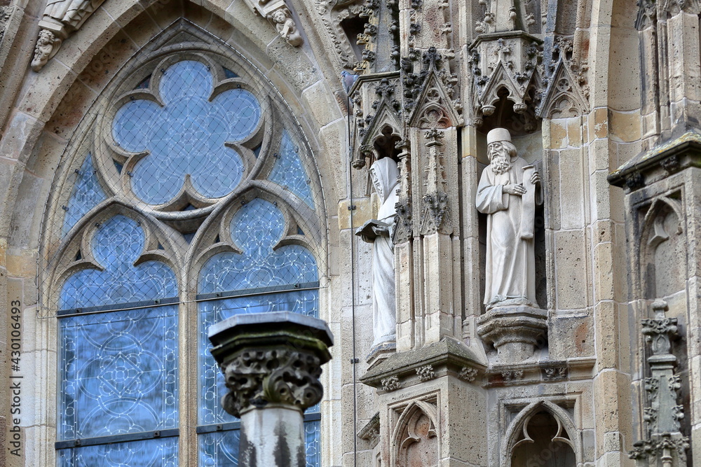 Close-up on statues and ornaments (Dutch Gothic architecture) on the external facade of St Janskathedraal (St John's Cathedral), located in the historical center of Hertogenbosch, Netherlands