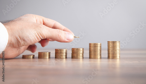 Male hand stacking coins. Saving money. Business. Investment