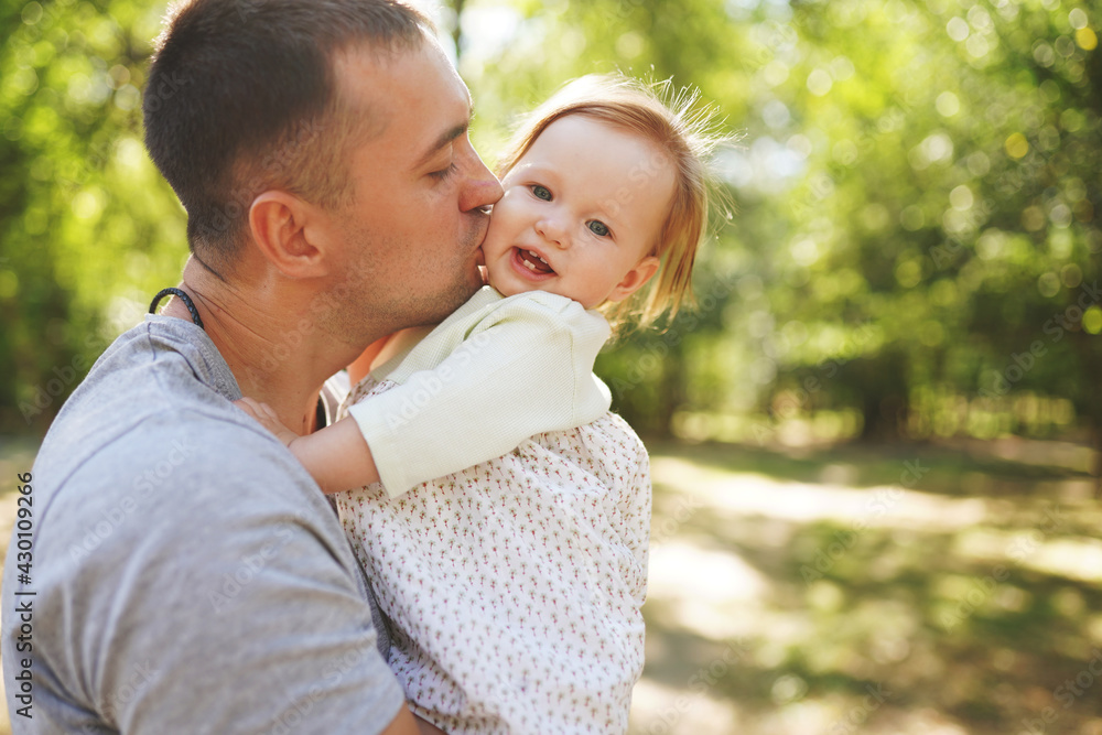 Happy young father spending time together with little daughter outdoors Happy young father spending time together with little daughter outdoors
