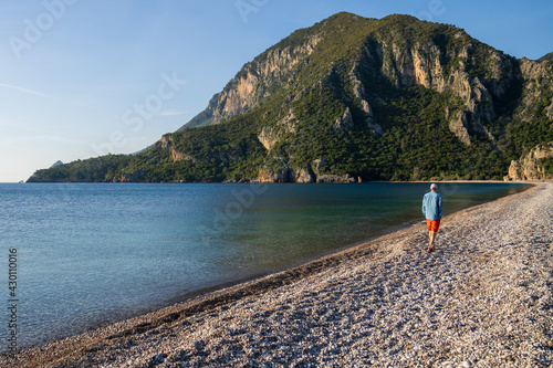 Man walking on Olympos Beach © Gunes