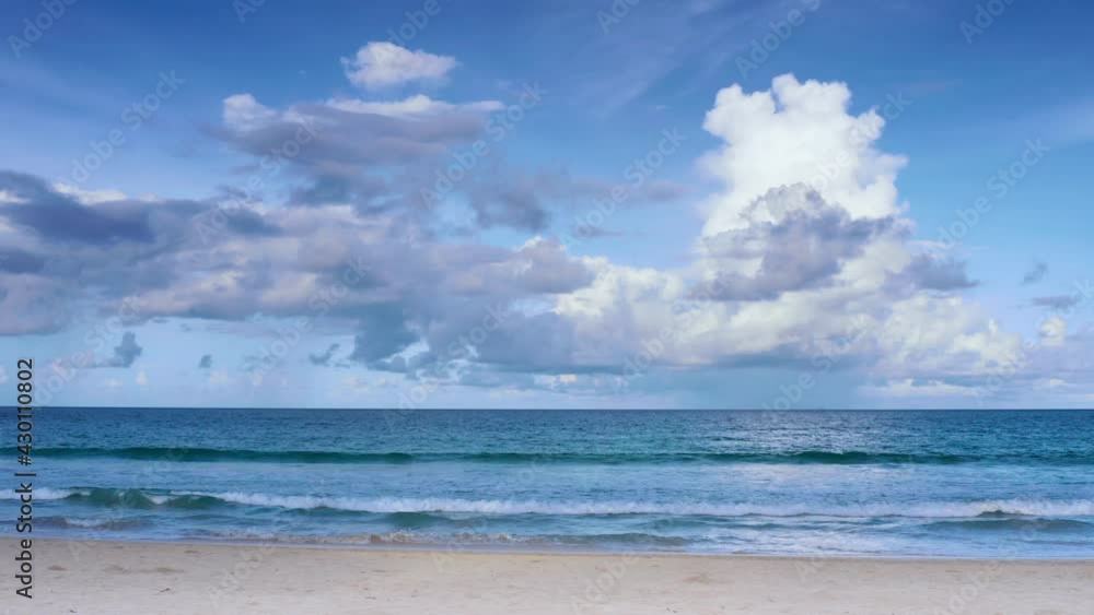 4K Beautiful tropical beach with blue sky and clouds. Tropical beach with waves crashing empty beach. Andaman Phuket beach Thailand. 4K Beautiful tropical beach with blue sky and clouds. Tropical beach with waves crashing empty beach. Andaman Phuket beach Thailand.