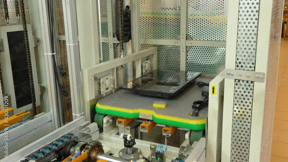 The computer case moves along a conveyor belt and is loaded into an elevator. The computer case moves along a conveyor belt and is loaded into an elevator.