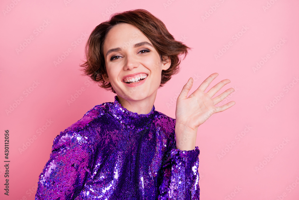 Photo of young cheerful girl happy positive smile wave hello wear squint dress isolated over pink color background Photo of young cheerful girl happy positive smile wave hello wear squint dress isolated over pink color background