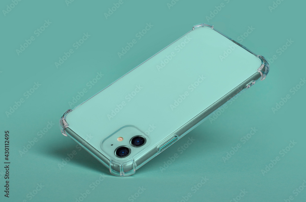 Green smartphone in clear silicone case falls down, back view isolated on green background, phone case mockup Green smartphone in clear silicone case falls down, back view isolated on green background, phone case mockup