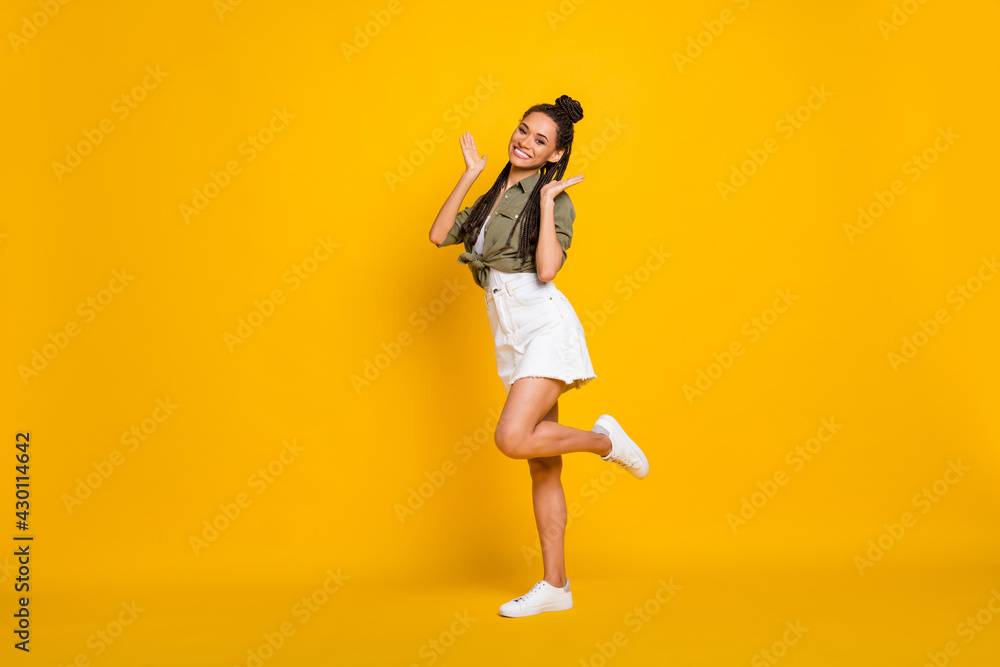 Photo portrait full body view of cute girl standing on one leg isolated on vivid yellow colored background