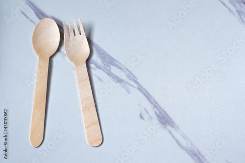 Wooden spoon and fork on gray background Copy space