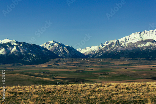 Scenic shot of beautiful landscape field below the snowy Wallowa Mountains in Joseph, Oregon photo